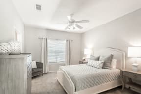 a bedroom with a bed and a ceiling fan