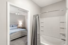 a bedroom with a bed and a bathtub