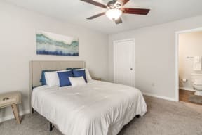 a bedroom with a bed and a ceiling fan