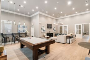 a games room with a pool table and a television