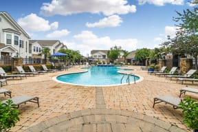 the preserve at ballantyne commons community pool with lounge chairs and umbrellas  at Kingston Crossing Apartment Homes, Bossier City