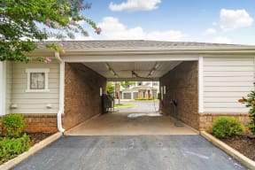 a carport with a driveway in front of a house  at Kingston Crossing Apartment Homes, Bossier City, LA
