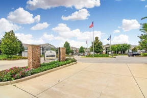 the preserve at ballantyne commons community entrance with american flags  at Kingston Crossing Apartment Homes, Bossier City