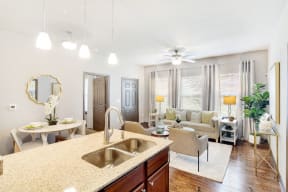 a living area with a kitchen counter and a living room in the background  at Kingston Crossing Apartment Homes, Bossier City, LA