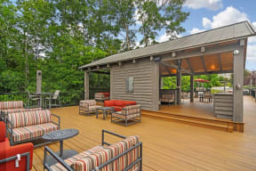 a large deck with furniture and a grill