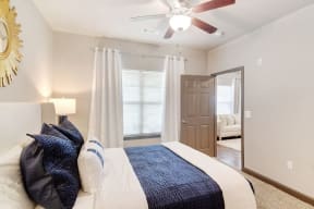 a bedroom with a large bed and a ceiling fan  at Kingston Crossing Apartment Homes, Bossier City, LA, 71111