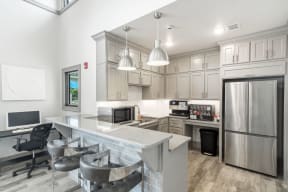a kitchen with a large white island and stainless steel appliances  at Parkwest Apartment Homes, Hattiesburg, 39402