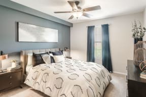 a bedroom with a large bed and a ceiling fan  at Parkwest Apartment Homes, Mississippi