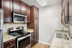 a kitchen with a stove top oven next to a sink