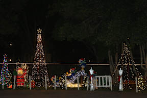 A Christmas display with a large tree and a snowman.