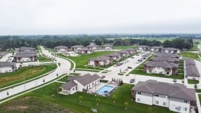 an aerial view of a neighborhood of apartments with a swimming pool