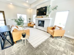 trendy clubhouse with couches rug TV and greenery