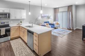 A modern kitchen with wooden cabinets and a white countertop.