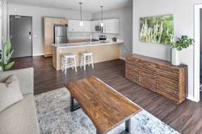 A modern kitchen with a wooden island and bar stools.