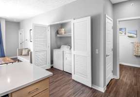 A kitchen with white appliances and cabinets.