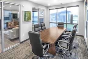 A conference room with a long table and chairs.