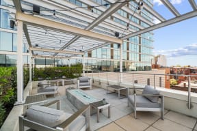 a view of the rooftop terrace with seating and a fire pit