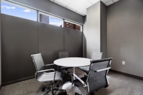 a small meeting room with a table and chairs