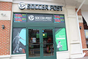 Soccer Post store front with a soccer player on the window.