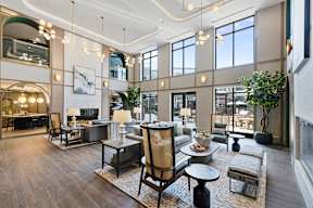 A modern living room with a large sofa set and a coffee table.