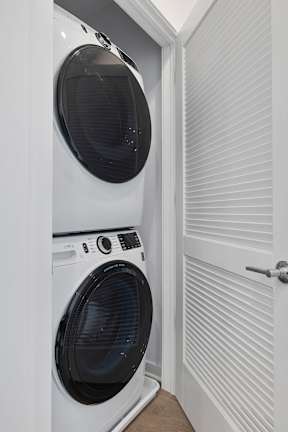 A white washing machine and dryer in a small laundry room.