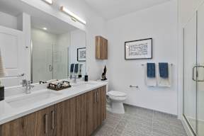 A bathroom with a white sink and a white toilet.
