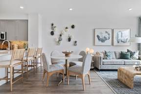 A modern dining room with a wooden table and chairs.