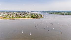 A large body of water with many sailboats floating on it.
