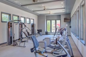 a gym with exercise equipment and windows at Century Lakeshore Crossings, Birmingham, AL