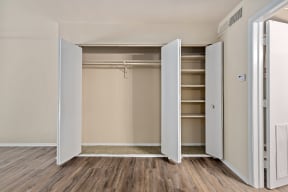 an empty bedroom with an open closet