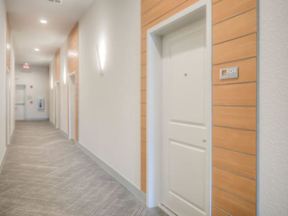 Indoor hallway lined with doors leading to apartment units at Lofts at South Lake, Clermont, 34711