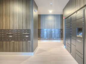 Modern mail and package room with multiple walls and boxes at Lofts at South Lake at Lofts at South Lake, Clermont, Florida