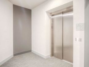 An elevator at the end of a hall, providing accessibility at Lofts at South Lake  at Lofts at South Lake, Florida, 34711