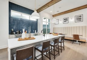 a kitchen with a long island with chairs and a counter top