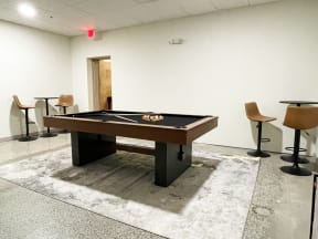 A room with a pool table in the middle of it at Land Bank Lofts in Columbia, SC