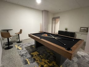 A game room with a pool table and a flat screen tv at Land Bank Lofts at Columbia, SC