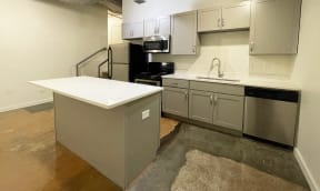 a kitchen with white cabinets and stainless steel appliances