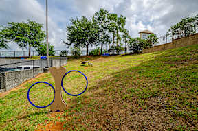 a playground with a pair of olympic rings in the grass at Lofts at South Lake, Clermont, FL, 34711