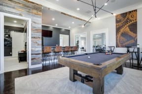 a pool table in a living room with a bar at Century Lakeshore Crossings, Birmingham Alabama