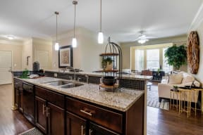 a kitchen with an island and a living room at Century Lakeshore Crossings, Birmingham
