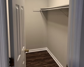 a small room with a closet and a door