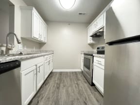 Stone Gate Apartments in Charlotte, NC, renovated kitchen with white shaker cabinets