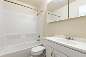 Bathroom with white cabinets and tub at Barracks West in Charlottesville, VA