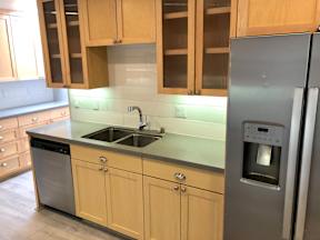 a kitchen with wooden cabinets and stainless steel appliances