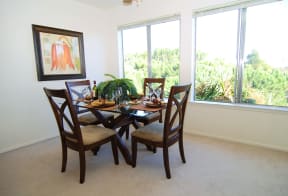 a four seat table dining set located inside of a unit looking into the white kitchen and beige carpet inside the unit Prodesse Property Group 1211 Garbo Way  San Jose, CA 95117