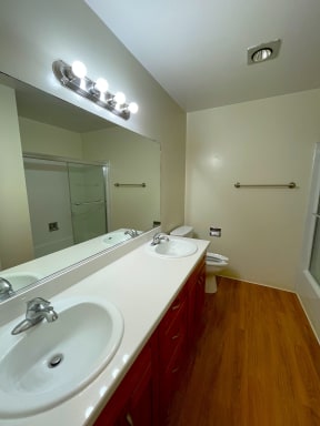Bathroom with double sink and toilet Exterior of the building with lots of Greenery Prodesse Property Group 418 Brahms Way Sunnyvale CA 94087
