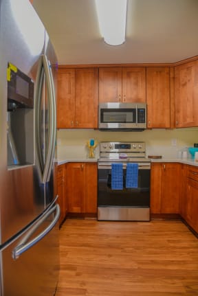 a kitchen with wood cabinets and stainless steel appliances