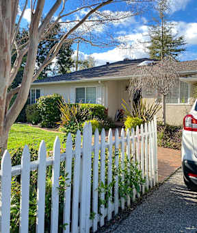 a white picket fence in front of a house