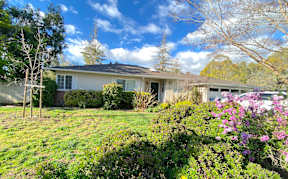 a house with a grassy yard in front of it
