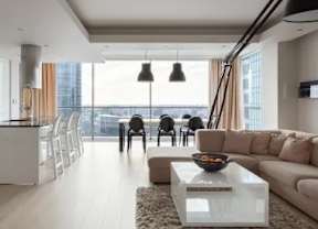 A modern living room with a large window overlooking the city.